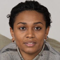 Joyful black young-adult female with short  brown hair and brown eyes