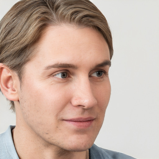 Joyful white adult male with short  brown hair and blue eyes