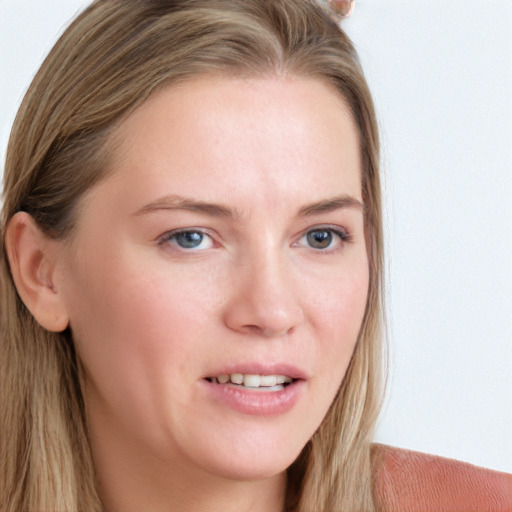 Joyful white young-adult female with long  brown hair and blue eyes