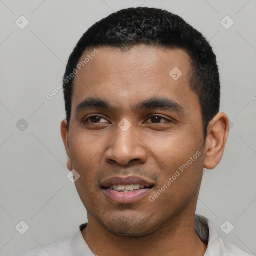 Joyful latino young-adult male with short  black hair and brown eyes