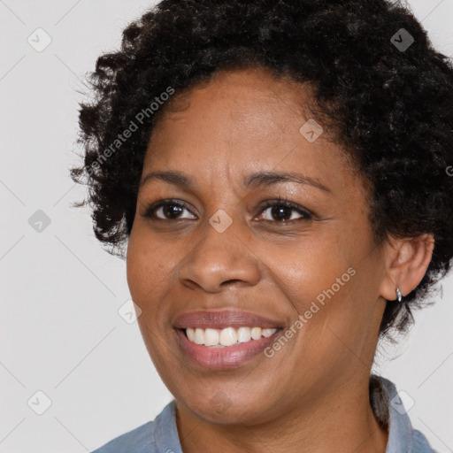 Joyful black young-adult female with medium  brown hair and brown eyes