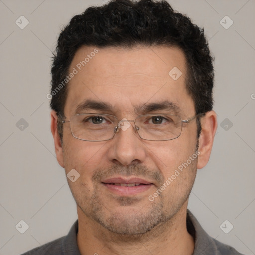 Joyful white adult male with short  black hair and brown eyes