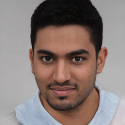 Joyful white young-adult male with short  black hair and brown eyes