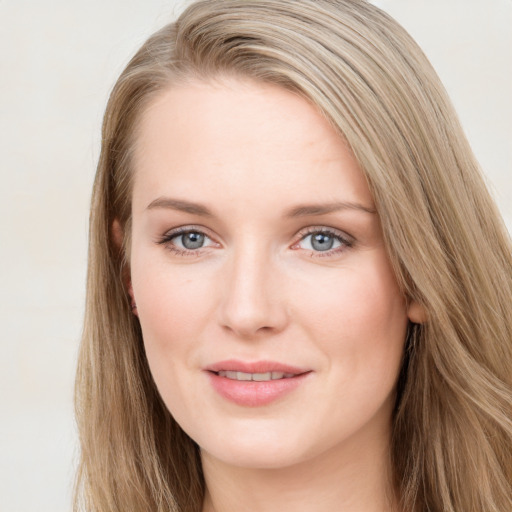 Joyful white young-adult female with long  brown hair and blue eyes