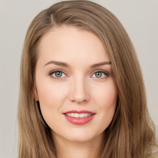 Joyful white young-adult female with long  brown hair and grey eyes