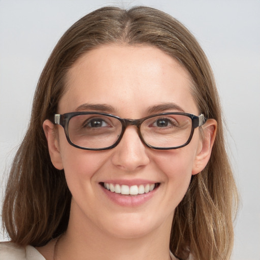 Joyful white young-adult female with long  brown hair and blue eyes