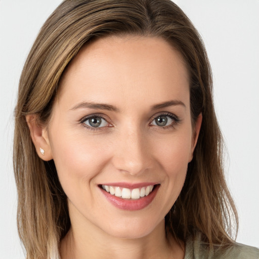 Joyful white young-adult female with long  brown hair and grey eyes