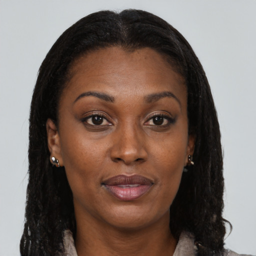 Joyful black young-adult female with long  brown hair and brown eyes