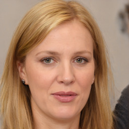 Joyful white adult female with long  brown hair and brown eyes