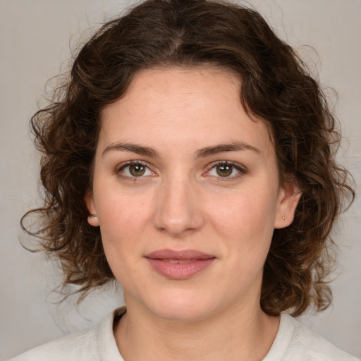 Joyful white young-adult female with medium  brown hair and green eyes