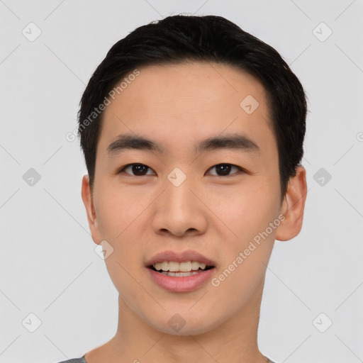 Joyful asian young-adult male with short  black hair and brown eyes