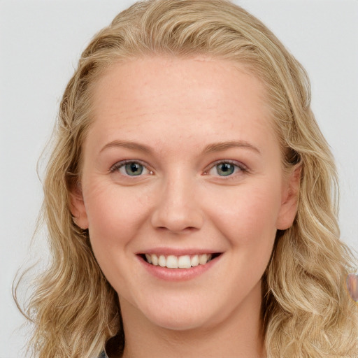 Joyful white young-adult female with long  brown hair and blue eyes