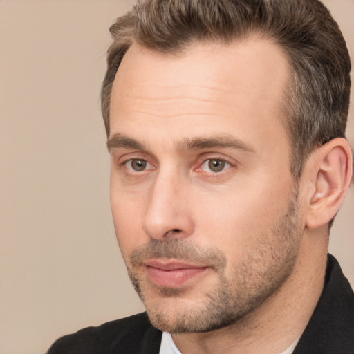 Joyful white adult male with short  brown hair and brown eyes