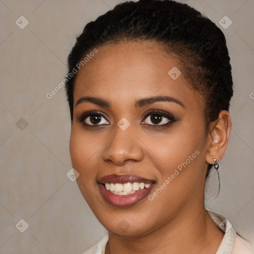 Joyful black young-adult female with short  black hair and brown eyes