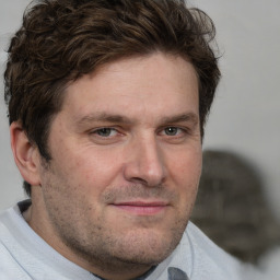 Joyful white adult male with short  brown hair and brown eyes