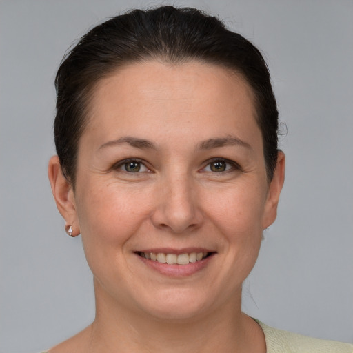 Joyful white adult female with short  brown hair and brown eyes