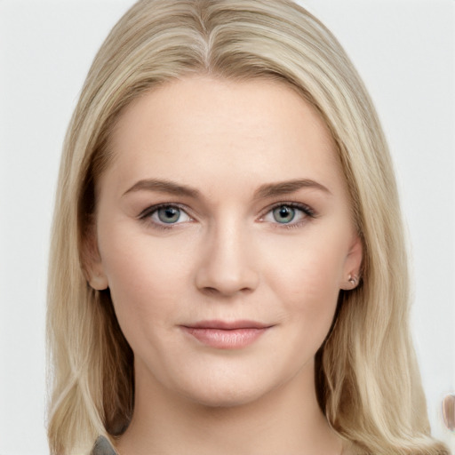 Joyful white young-adult female with long  brown hair and blue eyes