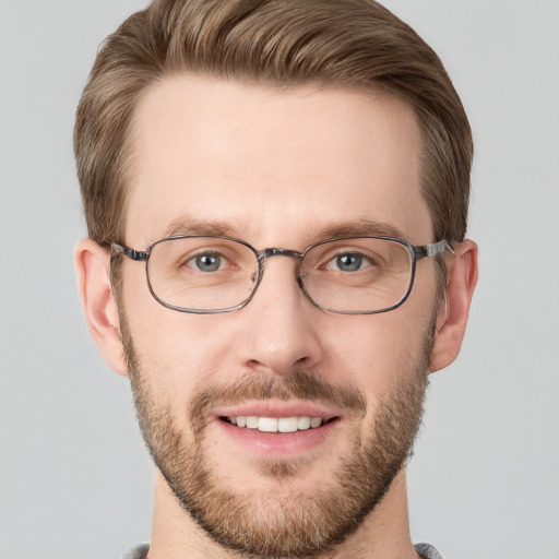 Joyful white adult male with short  brown hair and grey eyes