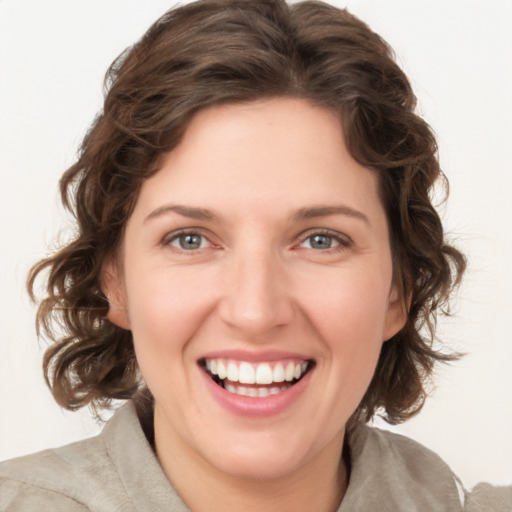 Joyful white young-adult female with medium  brown hair and green eyes