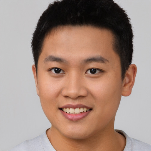 Joyful asian young-adult male with short  brown hair and brown eyes