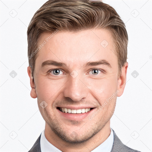 Joyful white young-adult male with short  brown hair and grey eyes