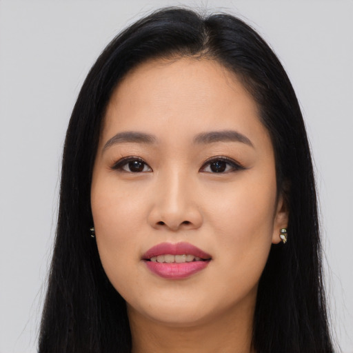 Joyful asian young-adult female with long  black hair and brown eyes