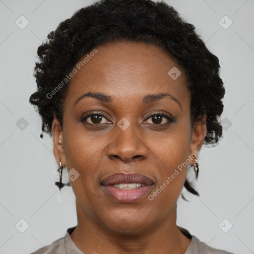 Joyful black adult female with short  brown hair and brown eyes
