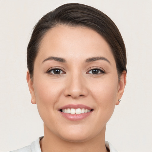 Joyful white young-adult female with short  brown hair and brown eyes