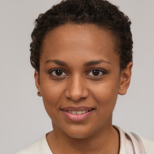 Joyful black young-adult female with short  brown hair and brown eyes
