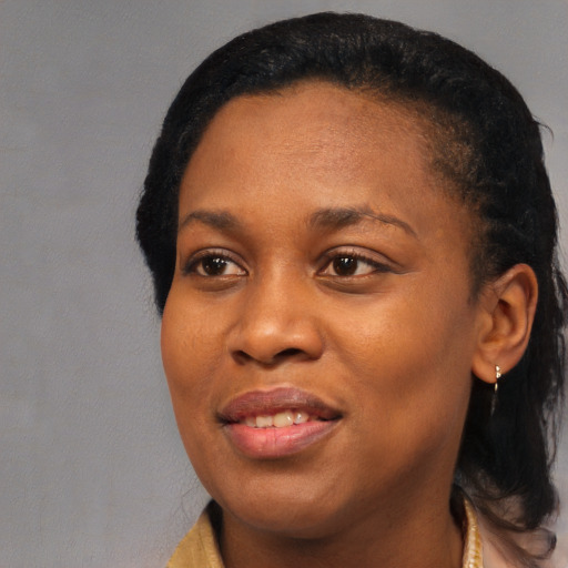 Joyful black young-adult female with medium  black hair and brown eyes