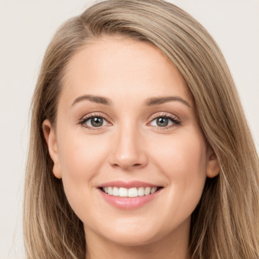 Joyful white young-adult female with long  brown hair and green eyes