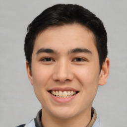 Joyful asian young-adult male with short  brown hair and brown eyes