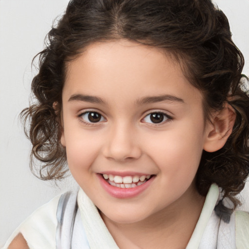 Joyful white child female with medium  brown hair and brown eyes