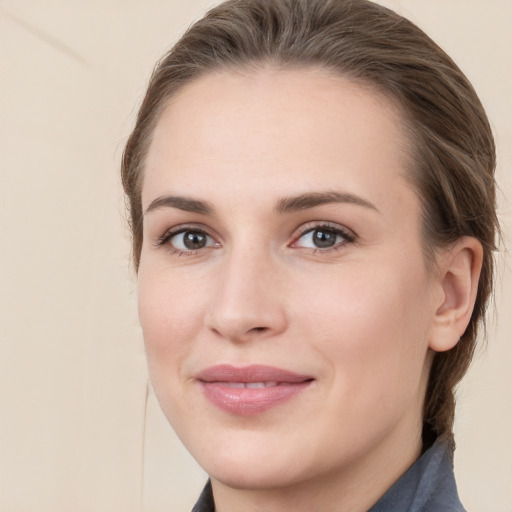 Joyful white young-adult female with medium  brown hair and grey eyes