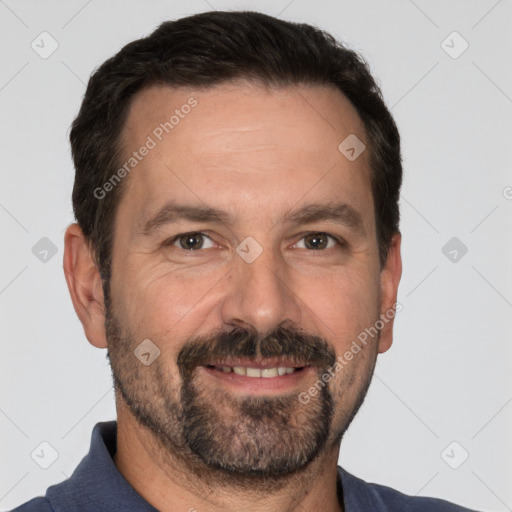 Joyful white adult male with short  black hair and brown eyes