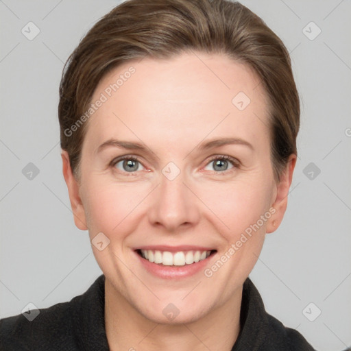 Joyful white adult female with short  brown hair and grey eyes