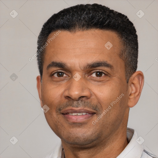 Joyful latino adult male with short  black hair and brown eyes