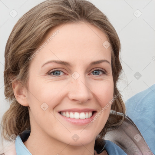 Joyful white young-adult female with medium  brown hair and blue eyes