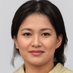 Joyful asian young-adult female with medium  brown hair and brown eyes