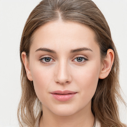 Joyful white young-adult female with long  brown hair and blue eyes