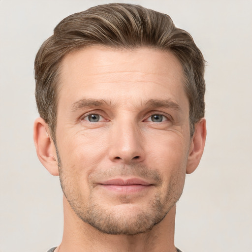 Joyful white adult male with short  brown hair and grey eyes