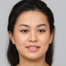 Joyful asian young-adult female with long  brown hair and brown eyes