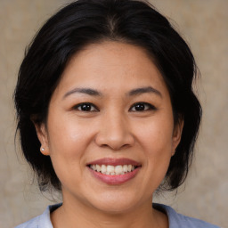 Joyful white adult female with medium  brown hair and brown eyes