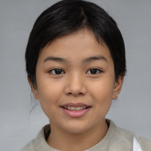 Joyful asian child female with medium  brown hair and brown eyes