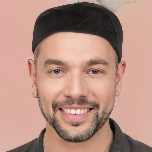 Joyful white young-adult male with short  black hair and brown eyes