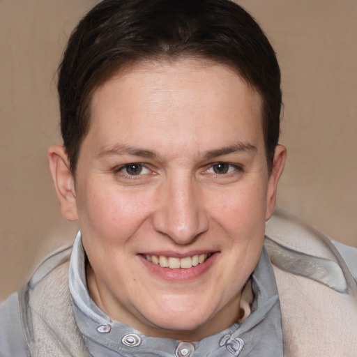 Joyful white adult female with short  brown hair and grey eyes