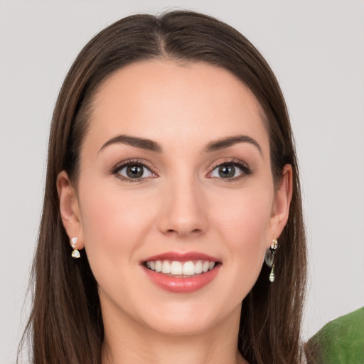 Joyful white young-adult female with long  brown hair and grey eyes