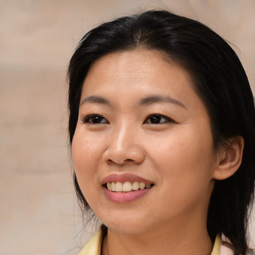 Joyful asian young-adult female with medium  brown hair and brown eyes