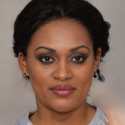 Joyful black young-adult female with short  brown hair and brown eyes