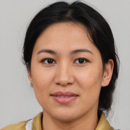 Joyful asian young-adult female with medium  brown hair and brown eyes